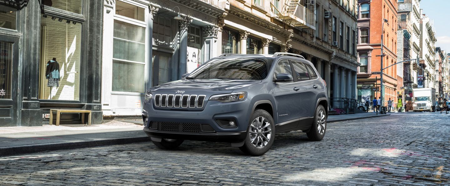 The 2021 Jeep Cherokee parked on a cobblestone street.