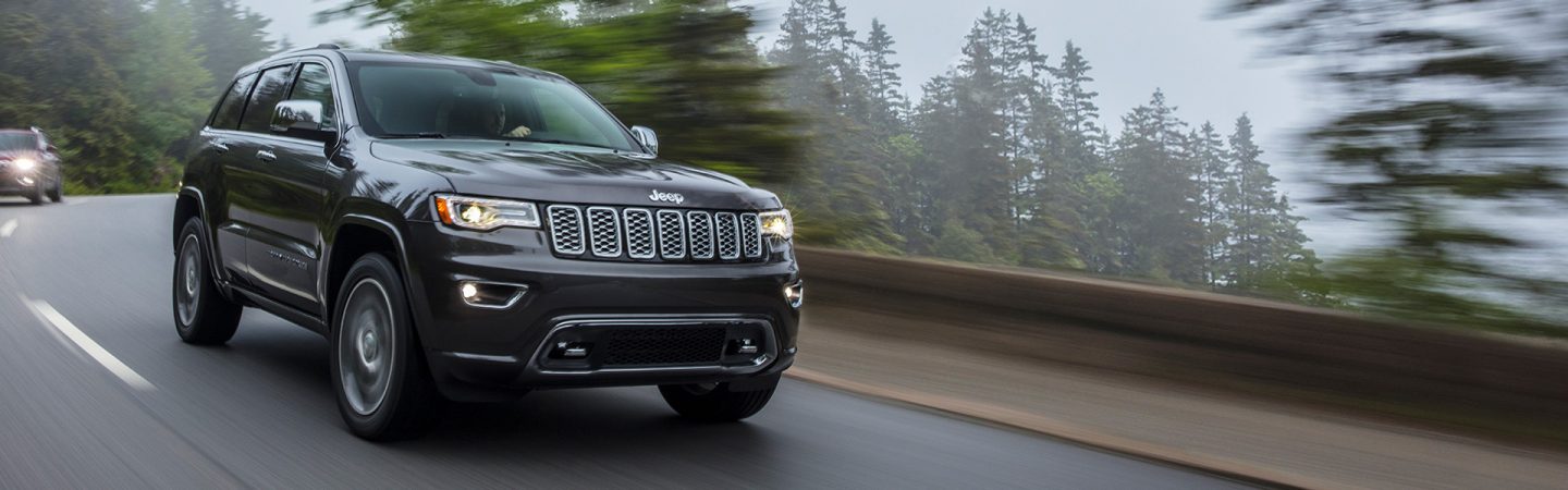 The 2021 Jeep Grand Cherokee Overland being driven on a mountain road.